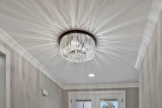 details with a notable chandelier, ornamental molding, and french doors