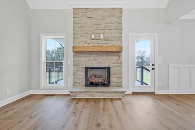 unfurnished living room with a fireplace and light hardwood / wood-style flooring