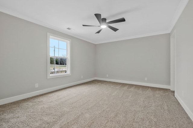 spare room featuring carpet flooring, crown molding, and ceiling fan