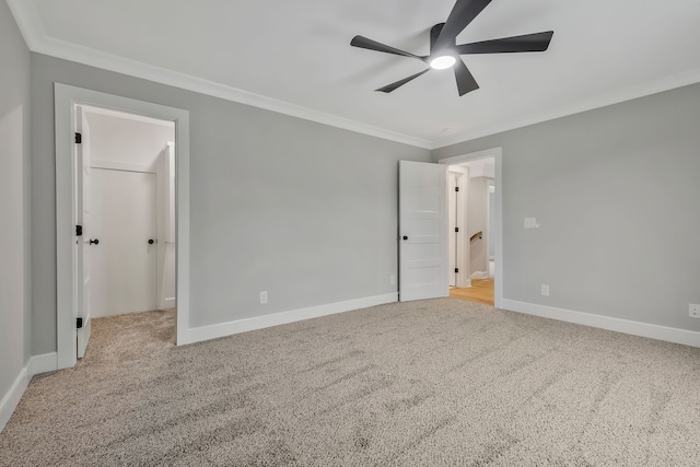 interior space featuring ceiling fan, light carpet, and ornamental molding