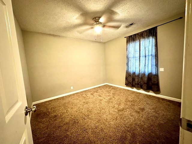 empty room with a textured ceiling, carpet floors, and ceiling fan