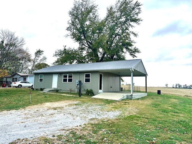 back of house with a yard and a patio