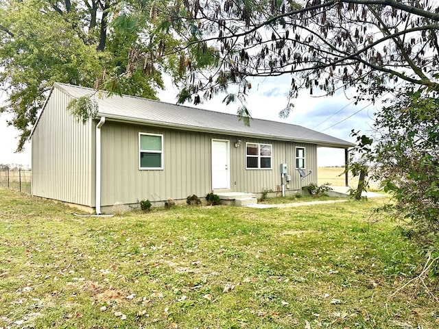 rear view of property with a yard