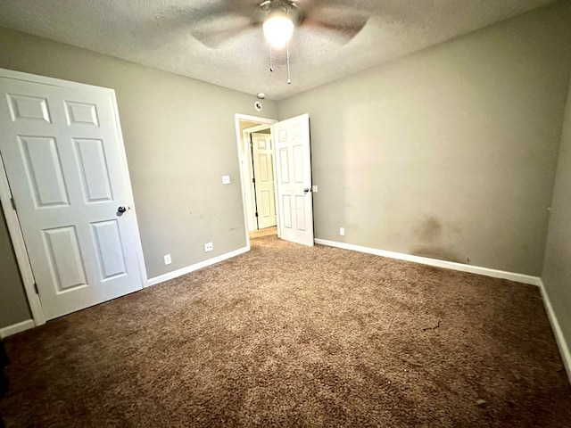 unfurnished bedroom with carpet, ceiling fan, and a textured ceiling