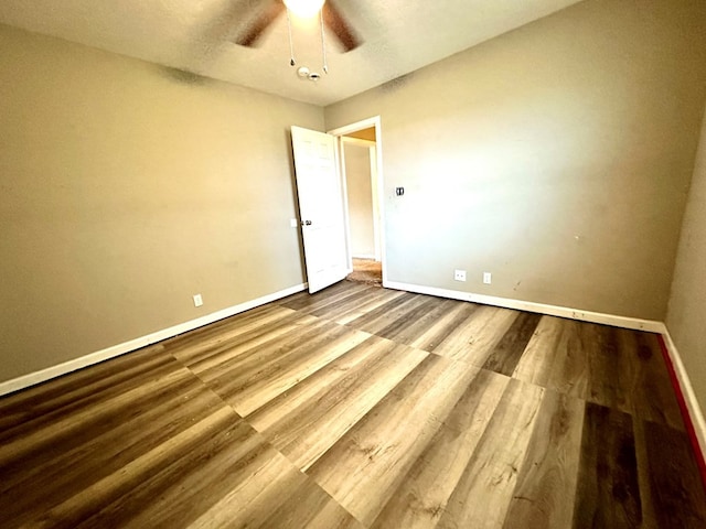 empty room featuring hardwood / wood-style floors and ceiling fan