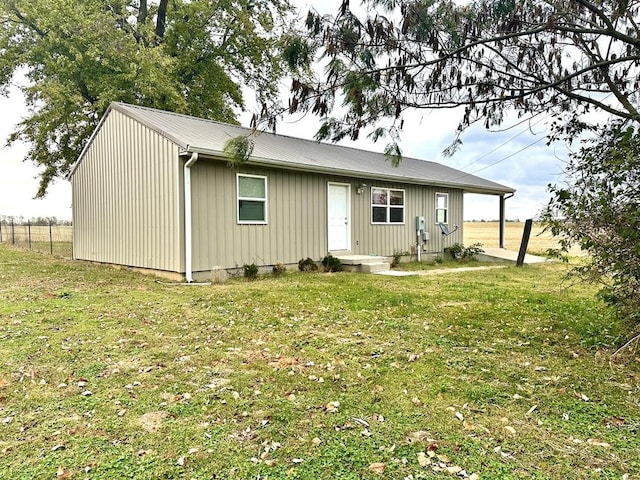 rear view of house with a lawn