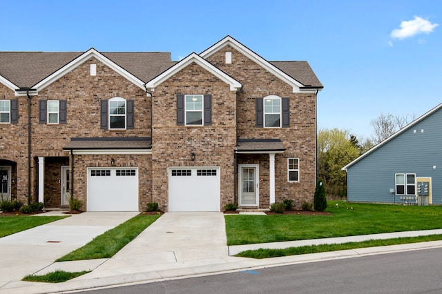 view of front of house featuring a front yard and a garage