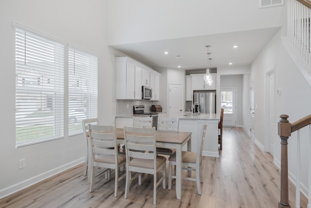 dining space featuring light hardwood / wood-style flooring and sink