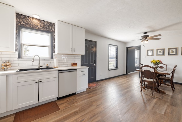 kitchen with ceiling fan, white cabinetry, white dishwasher, dark hardwood / wood-style floors, and sink