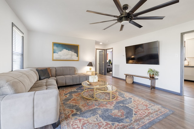 living room with hardwood / wood-style floors and ceiling fan