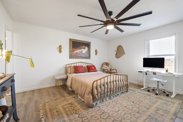 bedroom with hardwood / wood-style floors and ceiling fan