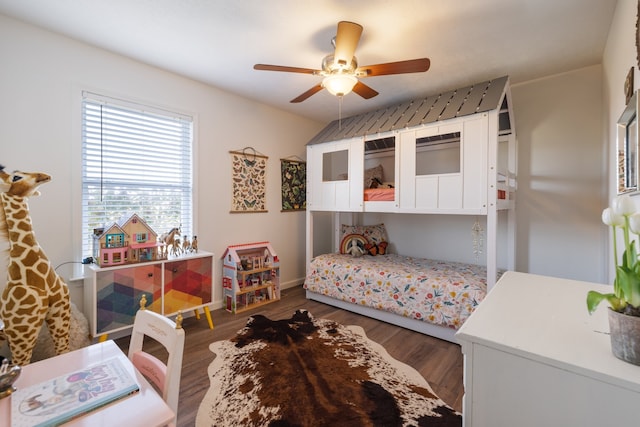 bedroom with dark hardwood / wood-style flooring and ceiling fan