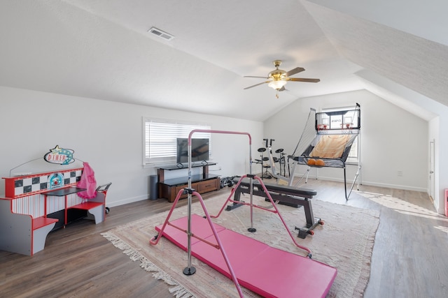 workout area with lofted ceiling, hardwood / wood-style flooring, and ceiling fan