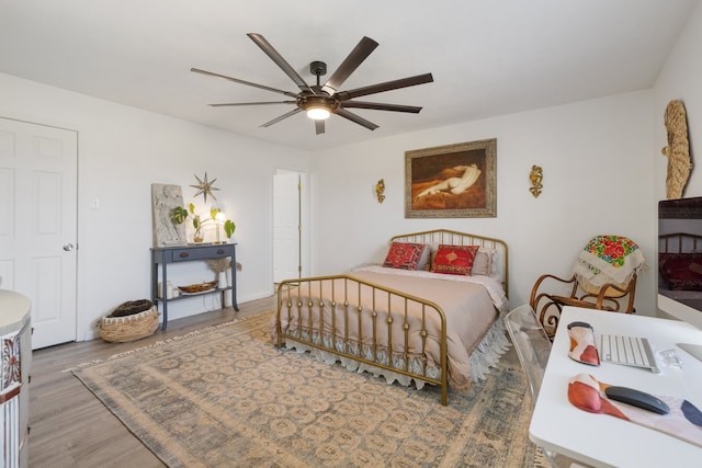 bedroom with hardwood / wood-style flooring and ceiling fan