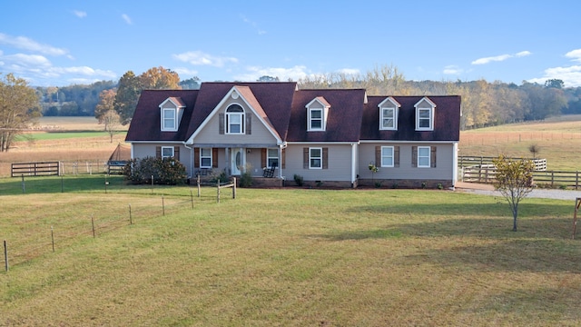 cape cod home featuring a rural view and a front yard