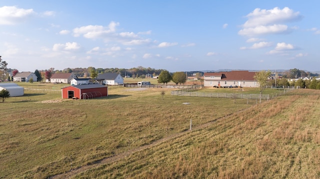 view of yard featuring an outbuilding and a rural view