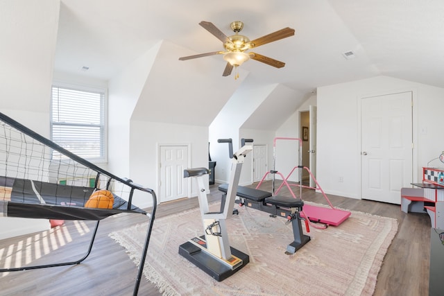 exercise room with lofted ceiling, wood-type flooring, and ceiling fan