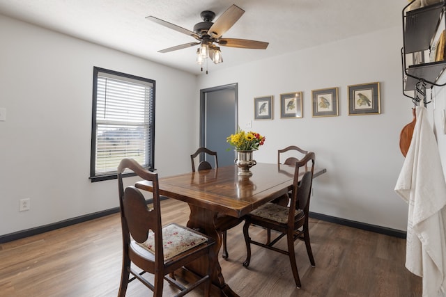 dining space with dark hardwood / wood-style floors and ceiling fan