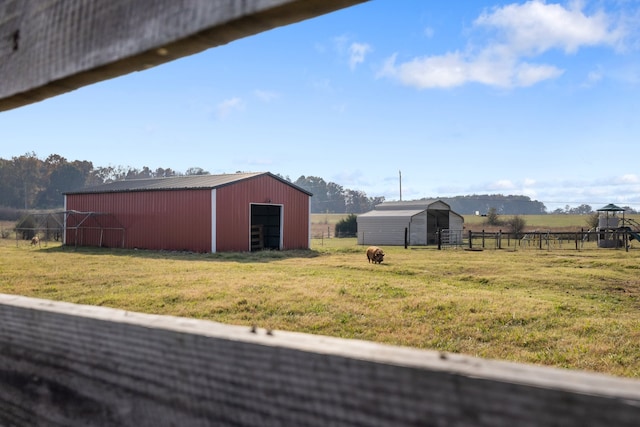 view of yard with a rural view and an outdoor structure