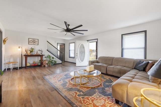 living room featuring ceiling fan and hardwood / wood-style flooring