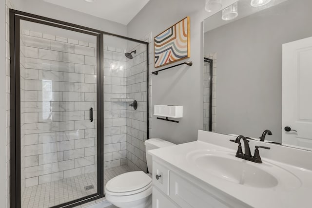 bathroom with vanity, toilet, and a shower with shower door