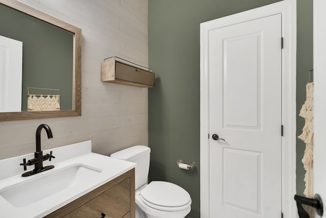 bathroom featuring toilet and vanity