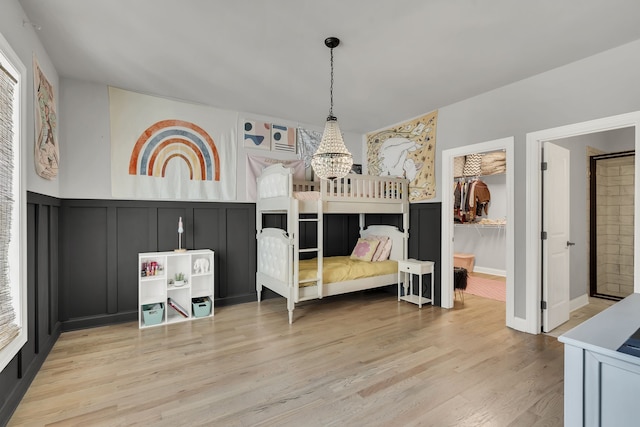 bedroom with a notable chandelier and light hardwood / wood-style flooring