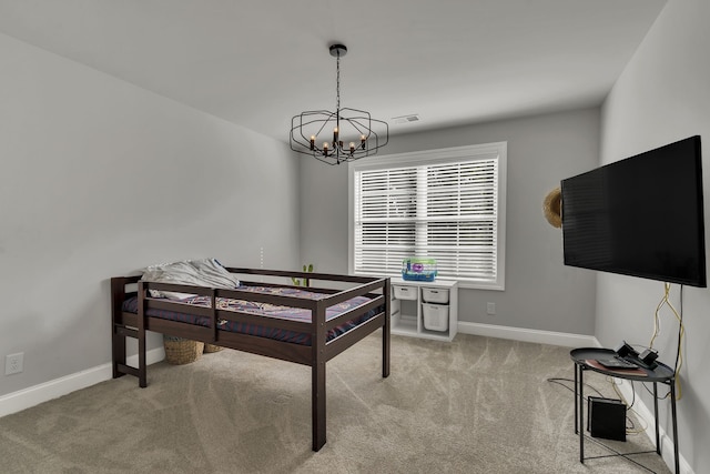 carpeted bedroom featuring a notable chandelier