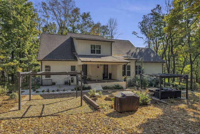 back of house with a patio, an outdoor living space, a hot tub, and a pergola