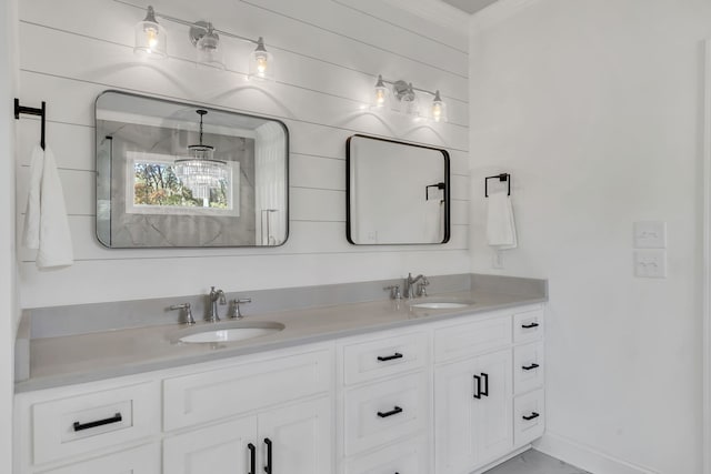 bathroom with vanity, an enclosed shower, and crown molding