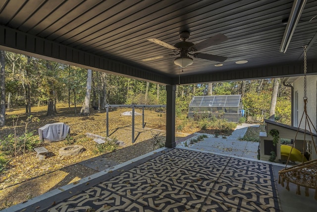 unfurnished sunroom with ceiling fan and a wealth of natural light