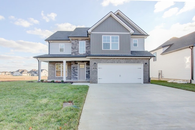 view of front of house with a porch, a garage, and a front lawn