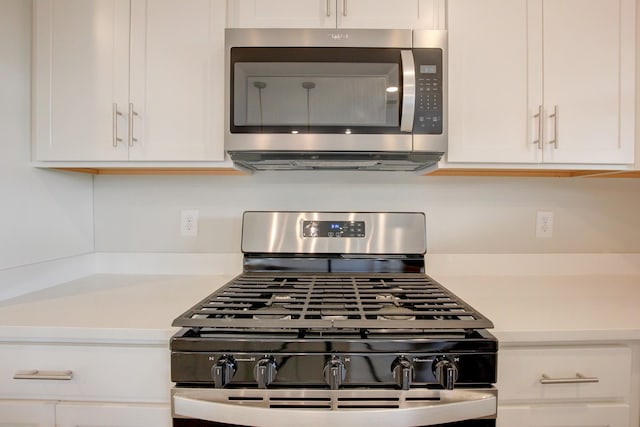 kitchen with white cabinets and appliances with stainless steel finishes