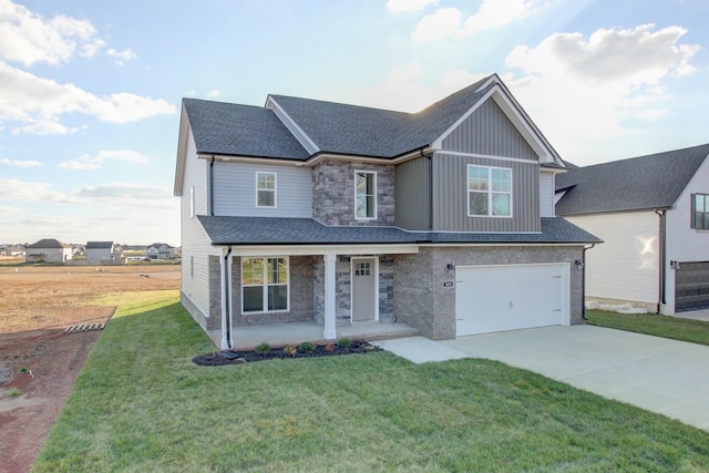 view of front of property featuring covered porch, a garage, and a front lawn