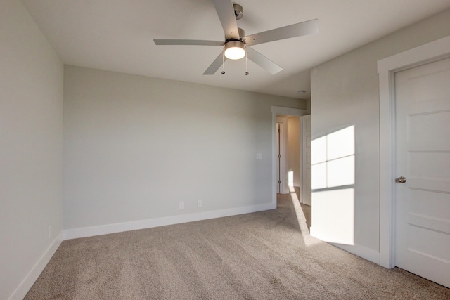 empty room featuring carpet flooring and ceiling fan