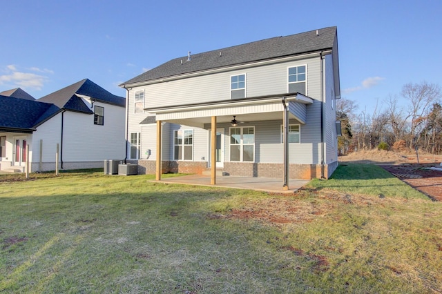 back of property featuring a lawn, a patio area, ceiling fan, and central air condition unit