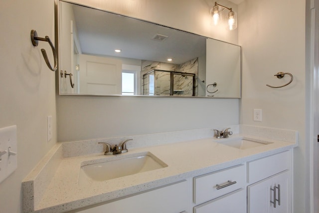 bathroom featuring vanity and a shower with door