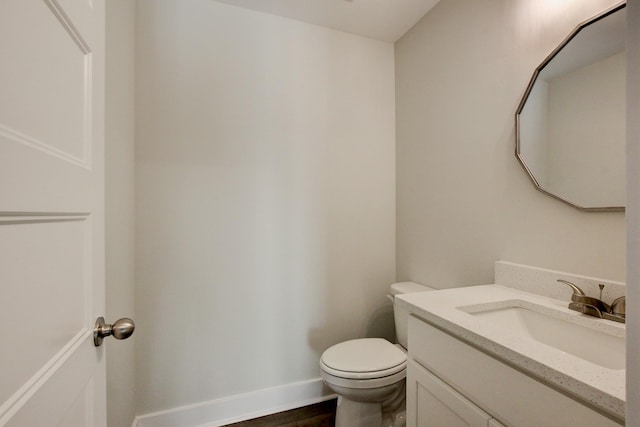 bathroom featuring tile patterned flooring, vanity, and toilet