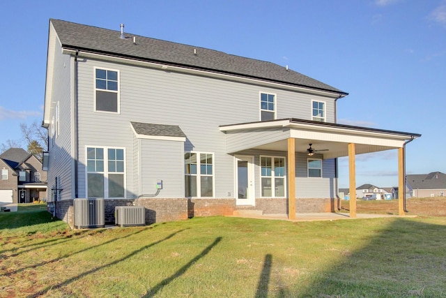 back of house featuring central AC, ceiling fan, and a yard