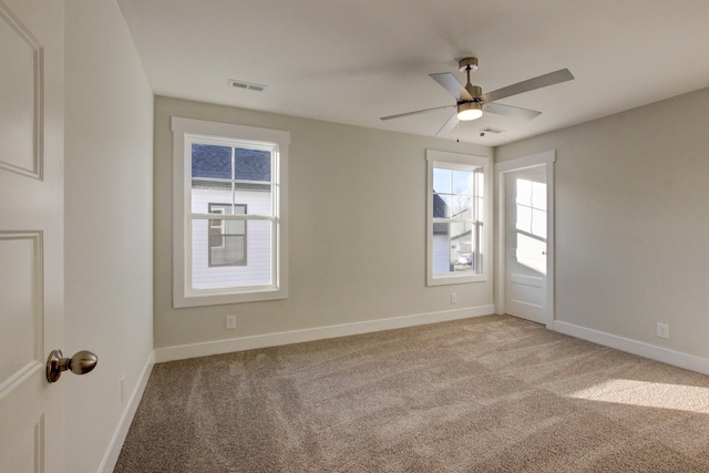 carpeted empty room featuring ceiling fan