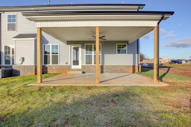 rear view of house with central AC, ceiling fan, a patio area, and a lawn