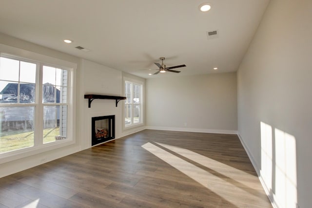 unfurnished living room with hardwood / wood-style flooring and ceiling fan