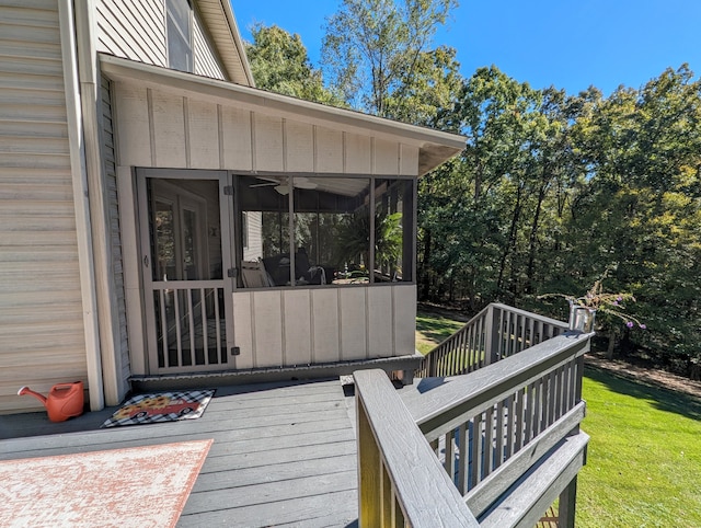 wooden terrace with a lawn and a sunroom