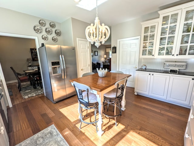 dining room featuring a chandelier and dark wood-type flooring