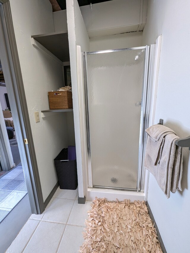 bathroom featuring tile patterned floors and an enclosed shower