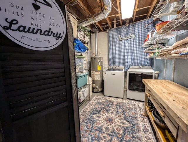 clothes washing area with washer and clothes dryer and water heater