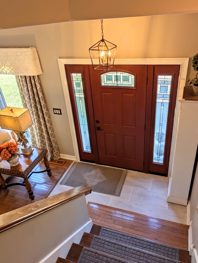 entryway featuring a chandelier and light hardwood / wood-style flooring