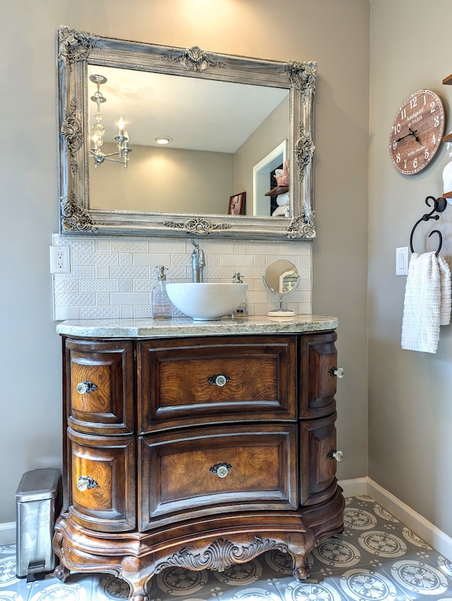 bathroom featuring vanity and backsplash