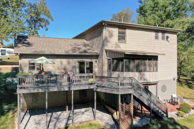 rear view of house with a sunroom and a deck