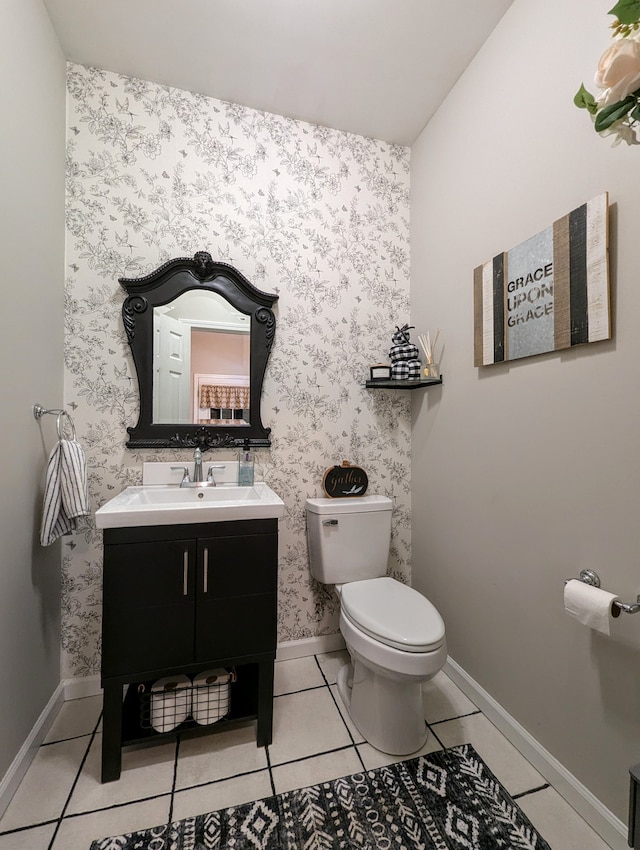 bathroom featuring tile patterned flooring, vanity, and toilet